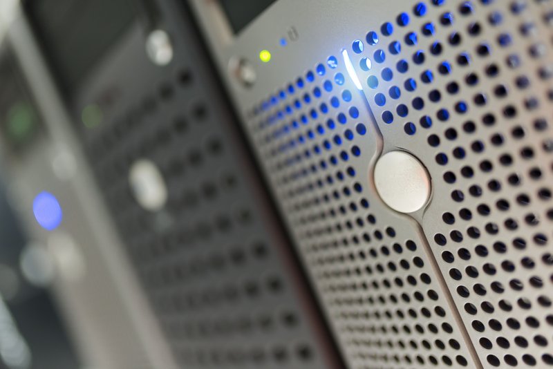 Server rack detail showing modern hardware with blue LED indicators, representing the physical infrastructure that lifecycle automation manages