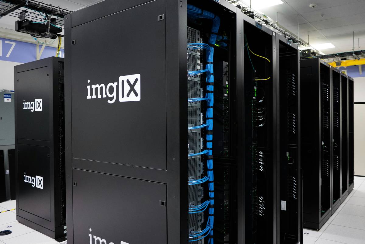 A modern server room with rows of racks illuminated by blue LED indicators, representing automated CMDB-driven infrastructure management