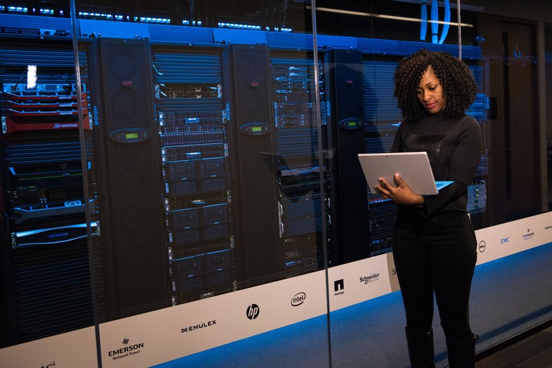 Data center engineer monitoring servers, representing the human oversight that complements automated discovery workflows