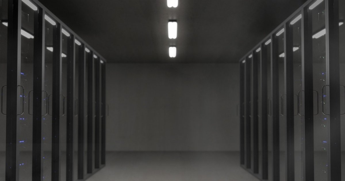 A dark server room with rows of rack-mounted equipment and status LEDs, representing the Linux kernel infrastructure where ftrace operates