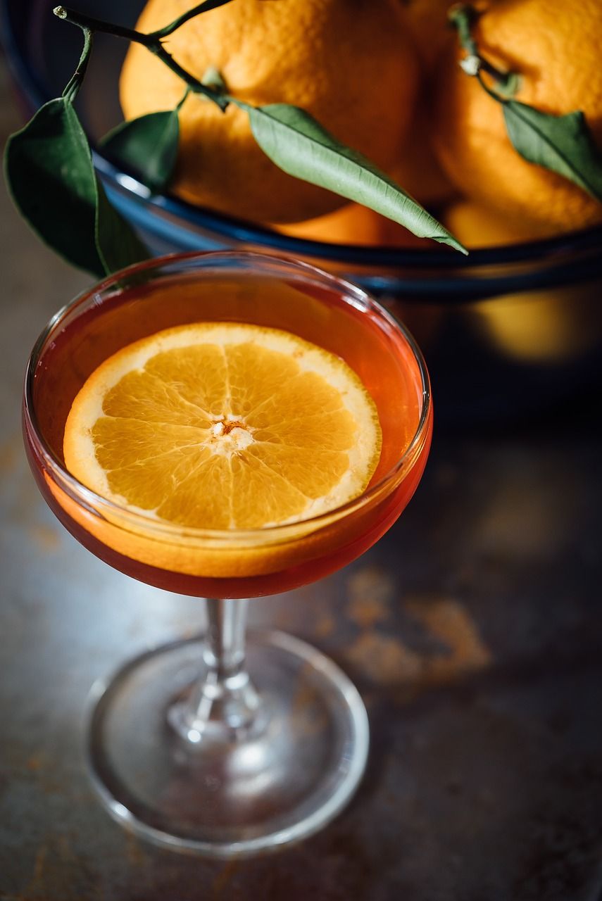 A beautifully garnished cocktail in a glass with citrus slice and ice, representing home mixology with common household ingredients