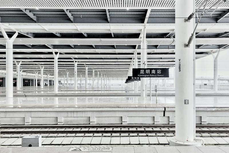 A modern train station platform representing the China-Laos Railway high-speed rail connecting Kunming to Pu'er in just 3 hours
