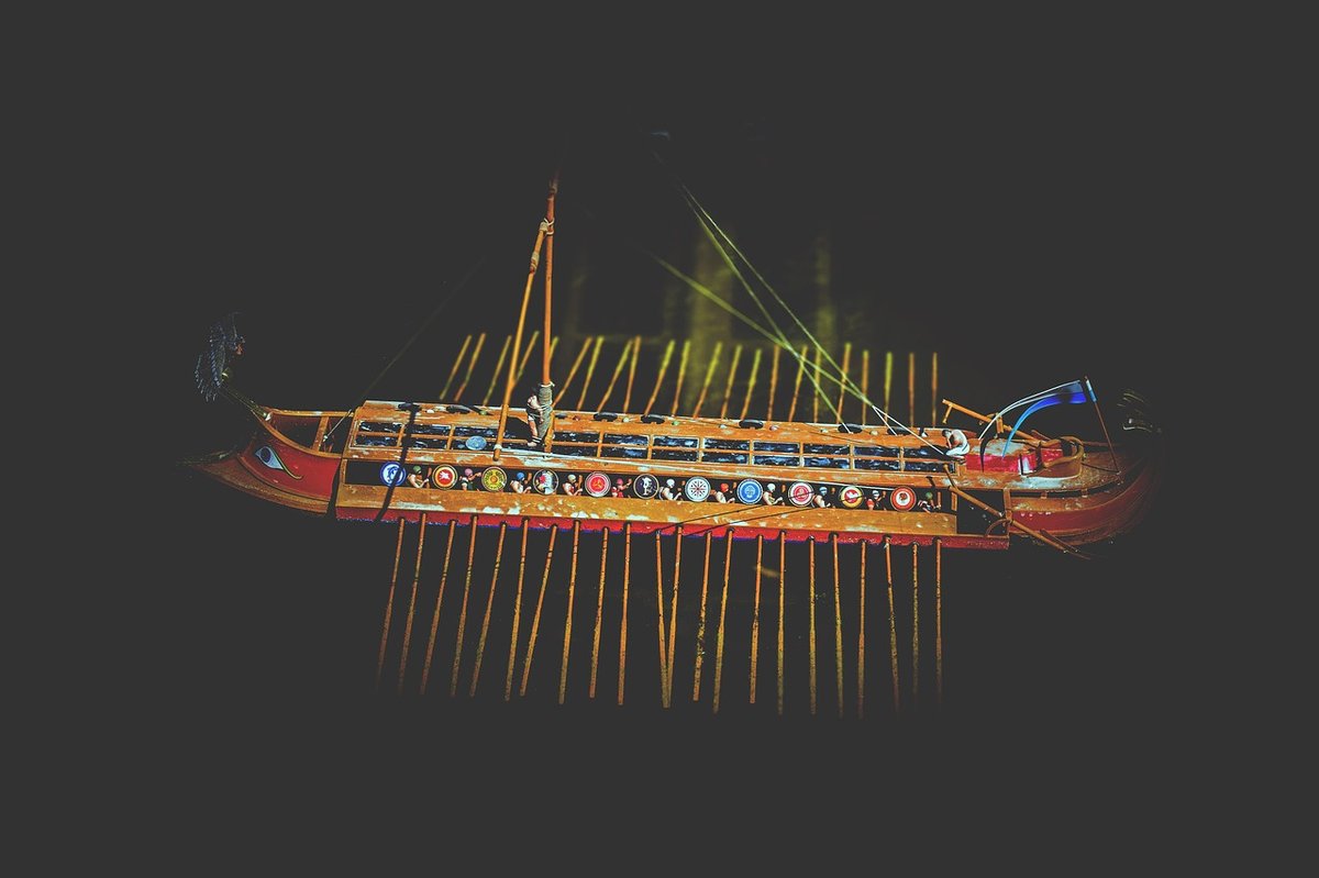 An ancient Greek sailing ship on open water, evoking Odysseus's long voyage home in Homer's epic poem