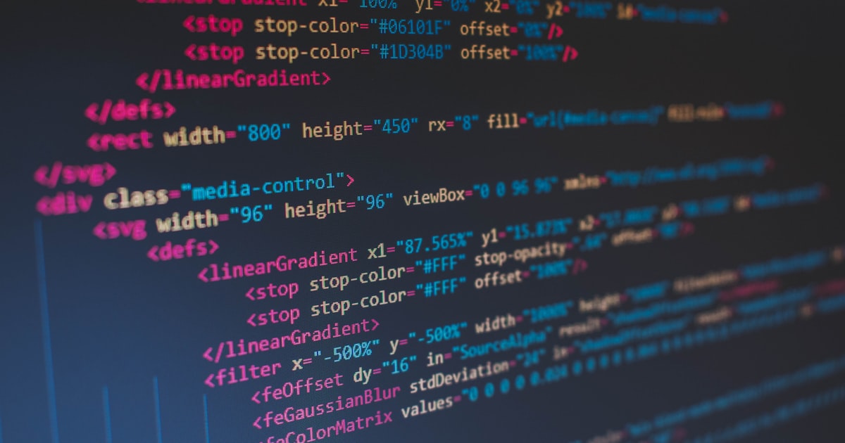 A computer monitor displaying lines of colorful source code on a dark background