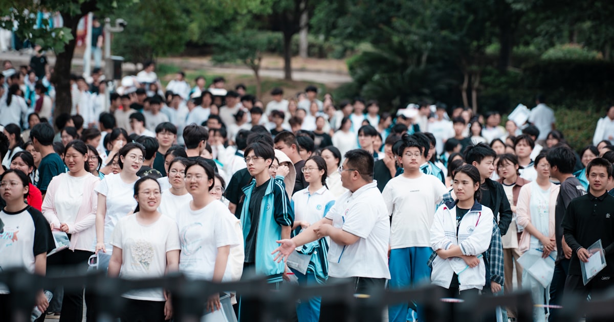 A large group of Chinese students gathered outdoors, representative of Shanghai's school-age population navigating AI-era education